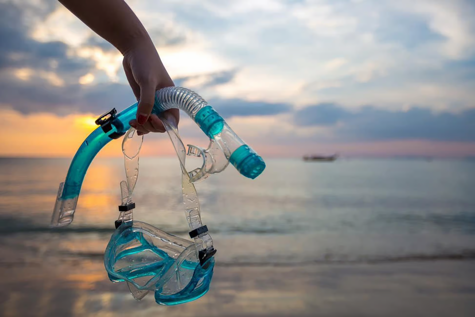 Touristen schnorcheln in den kristallklaren türkisfarbenen Gewässern des Great Barrier Reef nahe einer tropischen Sandbank in Cairns, Australien, und erleben dabei Meeresleben und eine unberührte Küstenlandschaft.