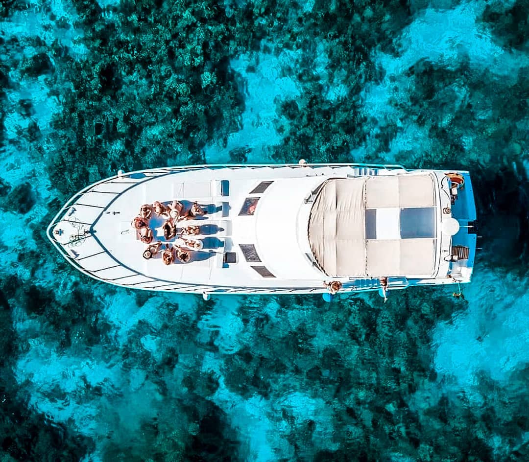 Happy family vacation. Young couple in snorkeling mask hold hand, dive underwater with fishes in coral reef sea pool. Travel lifestyle, watersport adventure, swim activity on summer beach holiday